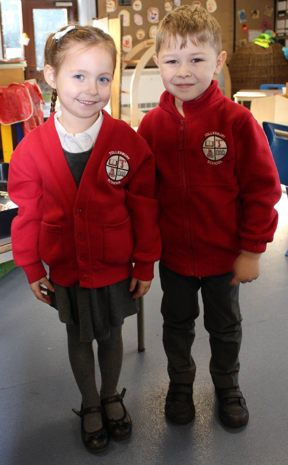 A girl and by wearing Tollesbury School Uniform 