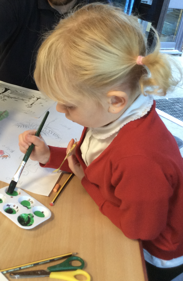 Year 2 Autumnal Artwork A girl holding a picture of a lino print of a sea bird.